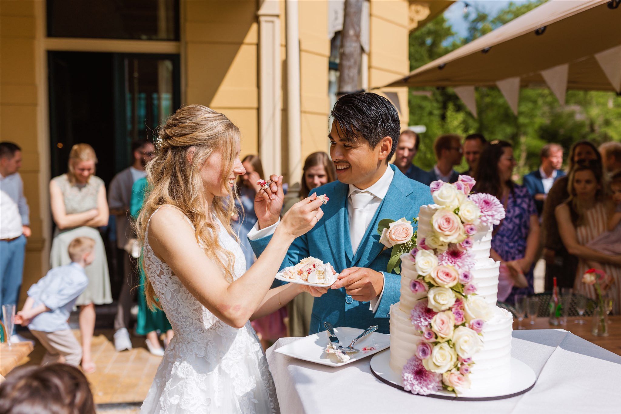 Bruidspaar voert elkaar taart tijdens de receptie van hun bruiloft bij Borg Nienoord